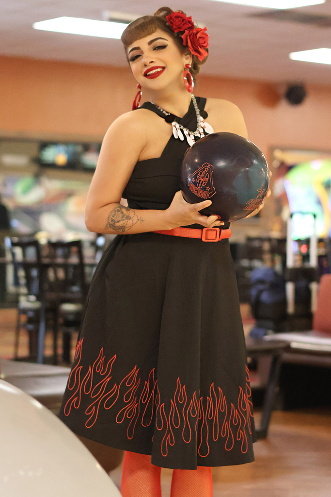 Goldie Moon holding a bowling ball with two hands.